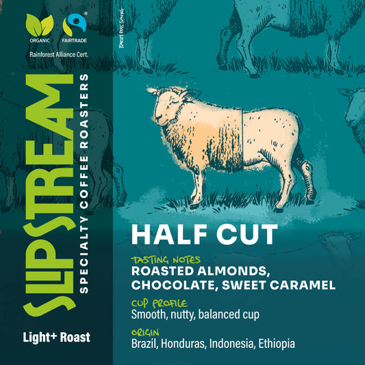 Half Cut Decaf.  Sheep half-shorn, showing its wool removed, calm and relaxed.